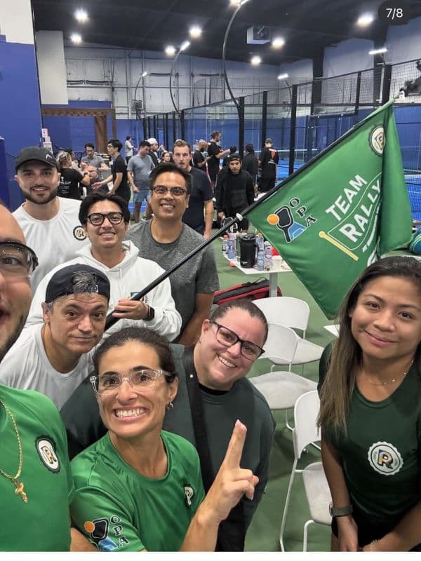 Team captain reviewing match lineup on phone at a pickleball tournament